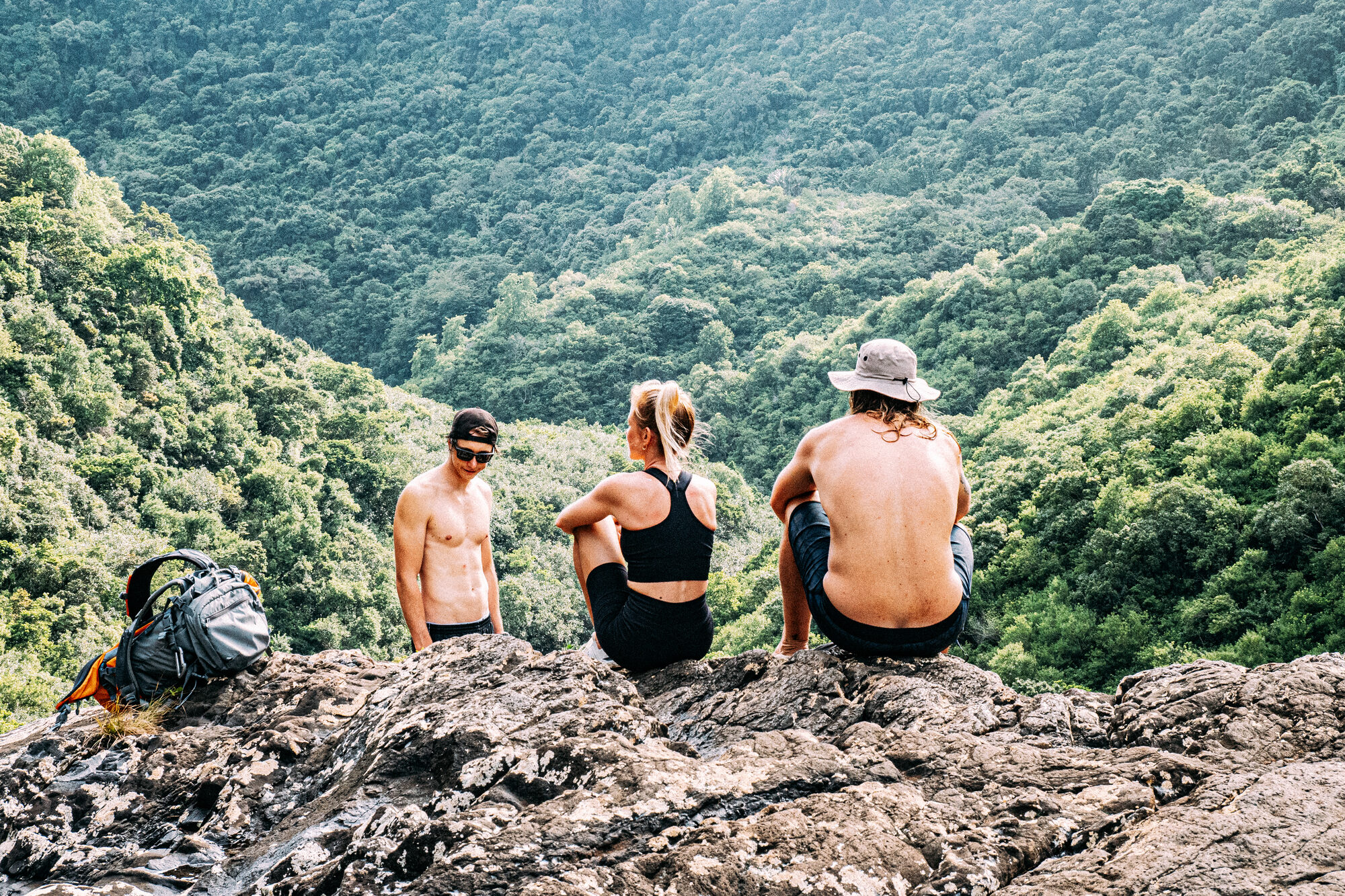 Friends hiking and riding wind over the green mountain landscape of Mauritius.